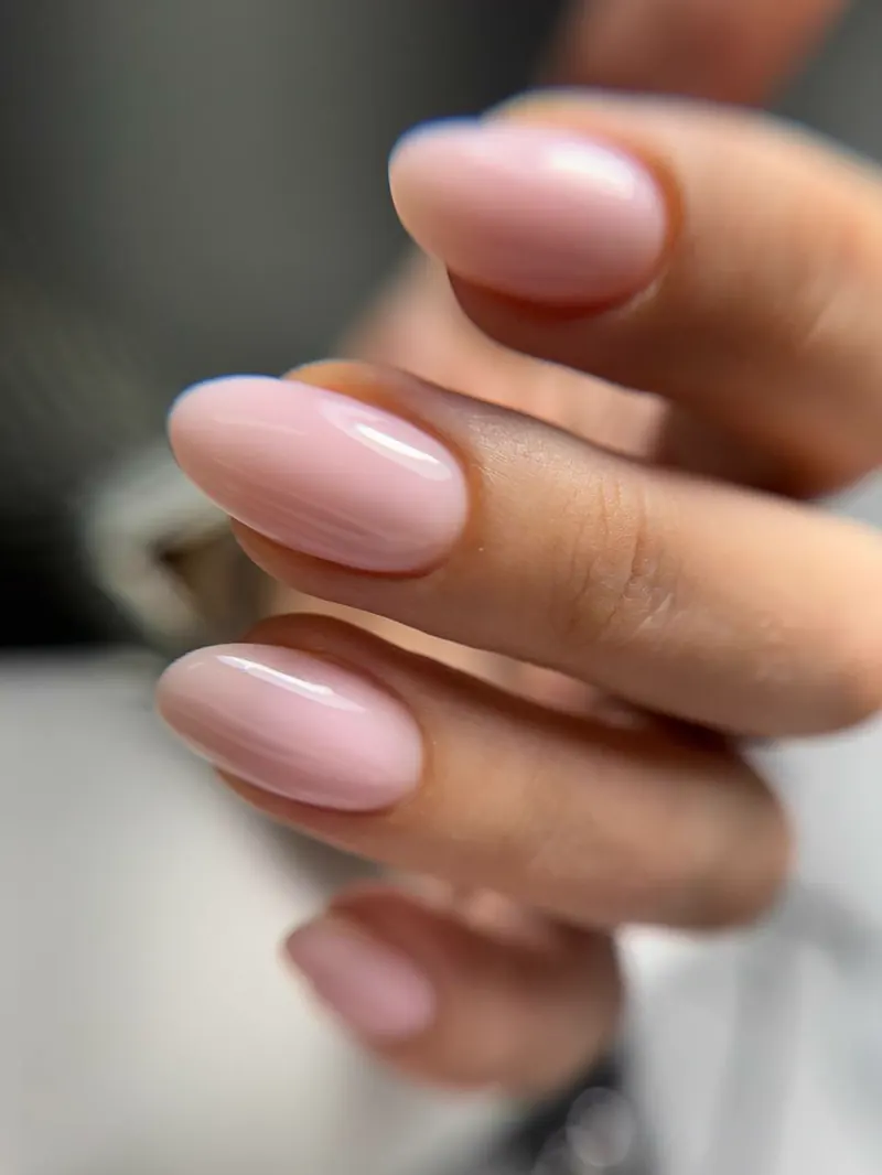 Glossy pink gel manicure with an almond shape